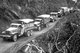Burma / Myanmar: US supplied Army trucks wind along the side of a mountain over the Ledo supply road from India into Burma, 1944